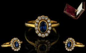 Ladies 18ct Gold Sapphire and Diamond Ring, of Oval Form, Set with Sapphire and Fourteen Diamonds.
