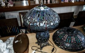 Large Tiffany Style Lamp in shades of blue, with a bulbous decorated base raised on four