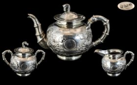 Chinese Export Three Piece Silver Tea Service With Embossed Floral Decoration And Bamboo Styled