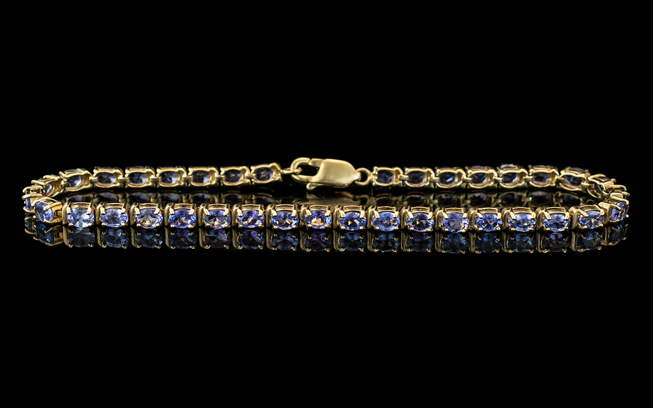 10ct Gold Attractive Blue Topaz Set Line Bracelet. Marked 10ct. Length 8 Inches - 20 cms. Weight 8.1