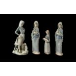 Four Lladro Figures, comprising two Lladro Porcelain Figurines No. 4650 'Girl with Calla Lillies'