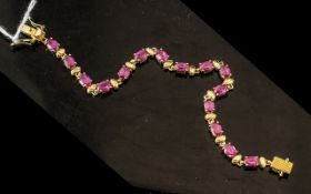 Ruby Line Bracelet, a row of oval cut rubies with a lovely raspberry hue, totalling 9cts,