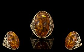 18ct Gold - Attractive Single Stone Amber Set Ring With Open Worked Ornate Designed Shank.