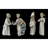 Four Lladro Figures, comprising 'Girl with Candle' No. 4868 8'' tall, Boy and Girl with Candle,