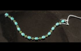 Amazonite and Russian Chrome Diopside Line Bracelet, a line of oval cut cabochons of natural blue