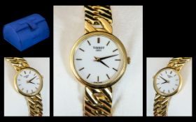 18ct Gold Ladies Tissot Wrist Watch, white enamel dial with baton numerals with 18ct gold integral