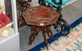 Small Octagonal Oriental Dragon Table, raised on four carved dragon legs, diameter 17'', height