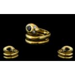 18ct Gold Snake Ring, in the form of a serpent with sapphire head and diamond eyes. Weight 10 grams.