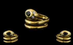 18ct Gold Snake Ring, in the form of a serpent with sapphire head and diamond eyes. Weight 10 grams.