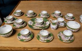 Minton Cockatrice Green Tea Set, comprising milk jug, two sugar bowls, 12 cups, 11 saucers, 10