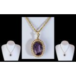 An Antique 15ct Gold Amethyst and Seed Pearl Pendant, large central amethyst approx. 20 x 15 ml,