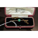 15ct Gold Bar Brooch, set with central turquoise and safety chain, length 2''. Gross Weight 4