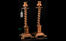 Pair of Copper Arts & Crafts Candlesticks, barley twist stick raised on column base with four square