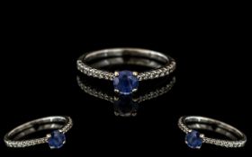 18ct Sapphire & Diamond Ring, central sapphire set between brilliant cut diamonds. Fully hallmarked.