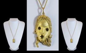 A Superb 18ct Gold - Cast Face Mask Pendant, Attached to a long 18ct Gold Chain. Marked 750 -