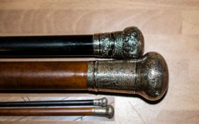 Two Silver Topped Walking Canes, with engraved pattern tops, one dark ebony coloured wood,