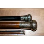 Two Silver Topped Walking Canes, with engraved pattern tops, one dark ebony coloured wood,