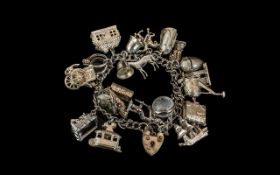 A Good Quality Vintage Sterling Silver Charm Bracelet Loaded with over 22 Silver Charms.