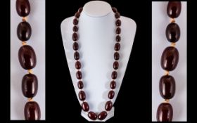 Faux Cherry Amber Double Knotted Barrel Shaped Beaded Necklace.