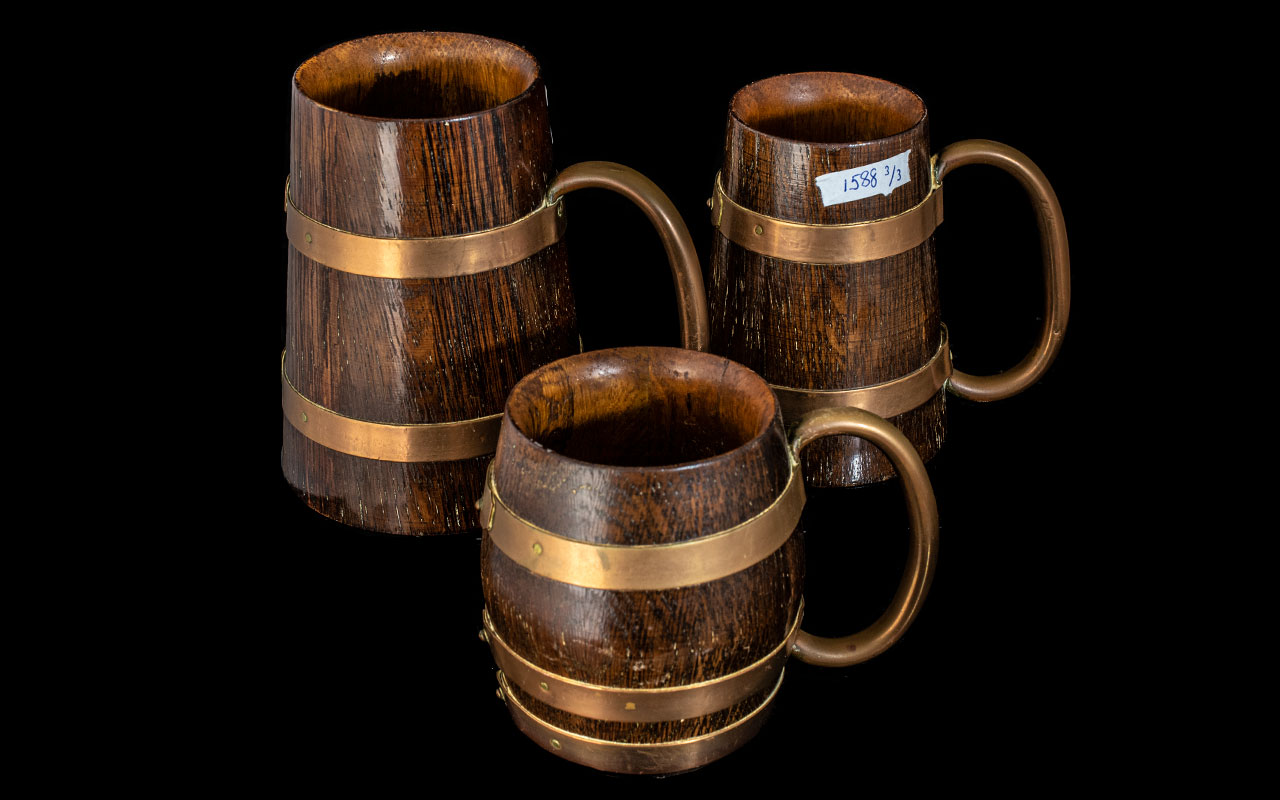 A Collection of Three Oak Tankards Copper Banding and Handles.
