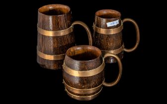 A Collection of Three Oak Tankards Copper Banding and Handles.
