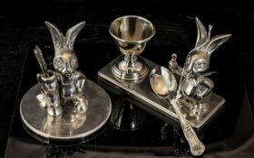 Two Table Top Stainless Steel Ornaments comprising an egg cup stand with spoon,