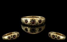 Early 20th Century - Attractive 9ct Gold Band Ring. Set with 3 Garnets In Star burst Surrounds.