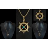 18ct Gold Novelty Realistic Ships Wheel Pendant Set with Turquoise and Sapphire to Centre.
