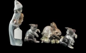 Four Lladro Figures, comprising two figures of cats with mice No. 4703, Rabbit figure No. 4772,