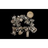 A Superb Vintage Sterling Silver Charm Bracelet Loaded with Over 20 Silver Charms.