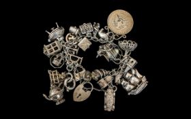 A Superb Vintage Sterling Silver Charm Bracelet Loaded with Over 20 Silver Charms.