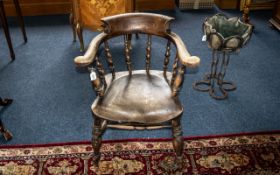 Oak Windsor Captain's Chair, bobbin turned. Traditional style, saddle seat, turned stretchers.