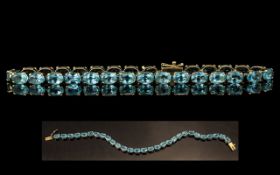 Ladies - 9ct Gold Pleasing Blue Topaz Set Line Bracelet. Fully Hallmarked for 9.375.