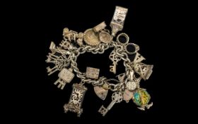 A Vintage Good Quality Sterling Silver Charm Bracelet - Loaded with Over 21 Good Silver Charms.