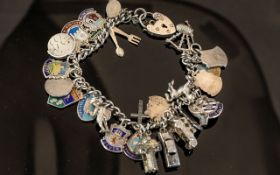 Silver Charm Bracelet With Heart Shaped Locket. Weight Approx 57.9 grams.