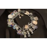 Silver Charm Bracelet With Heart Shaped Locket. Weight Approx 57.9 grams.