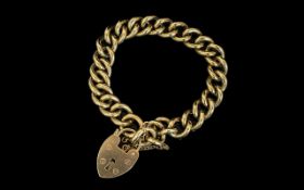 A Superb 9ct Gold Solid Curb Bracelet with 9ct Gold Heart Shaped Padlock and Safety Chain.