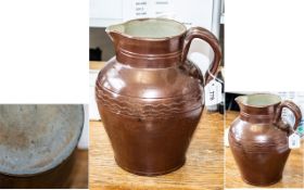 Large Antique Earthenware Glazed Jug, one handle, brown glaze with pattern to middle. Measures 10.