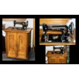 Vintage Gritzner German sewing machine housed in a wooden cabinet.