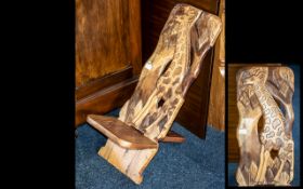 A Tribal Style Carved Two Part Birthing or Child's Low Chair.