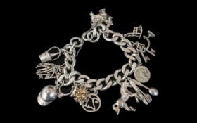 A Vintage Sterling Silver Charm Bracelet, loaded with eleven (11) good silver charms,