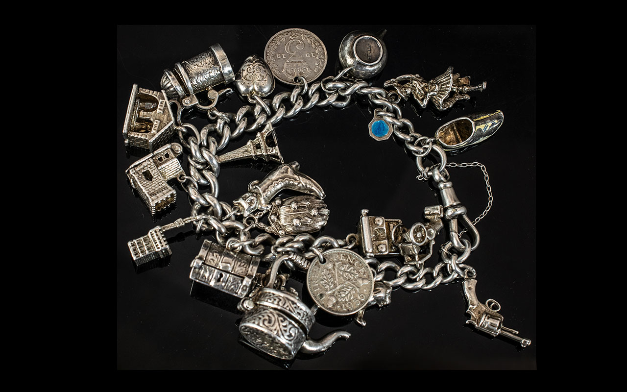 A Vintage Sterling Silver Charm Bracelet - Loaded with 18 Silver Charms. Some are Old Ones.