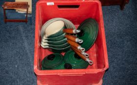 Set of Five French Cast Iron Pans with lids. Dark green with cream interior, wooden handles.