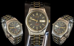 Seiko - Titanium Day-Date Gold and Steel Gent's Wrist Watch, with black dial and gold markers. No.