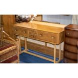 An Ercol Side Table With Two Central Short Drawers Between Two Large Drawers.