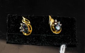 Mystic Topaz and Diamond Stud Earrings, each oval cut topaz displaying flashes of royal purple and