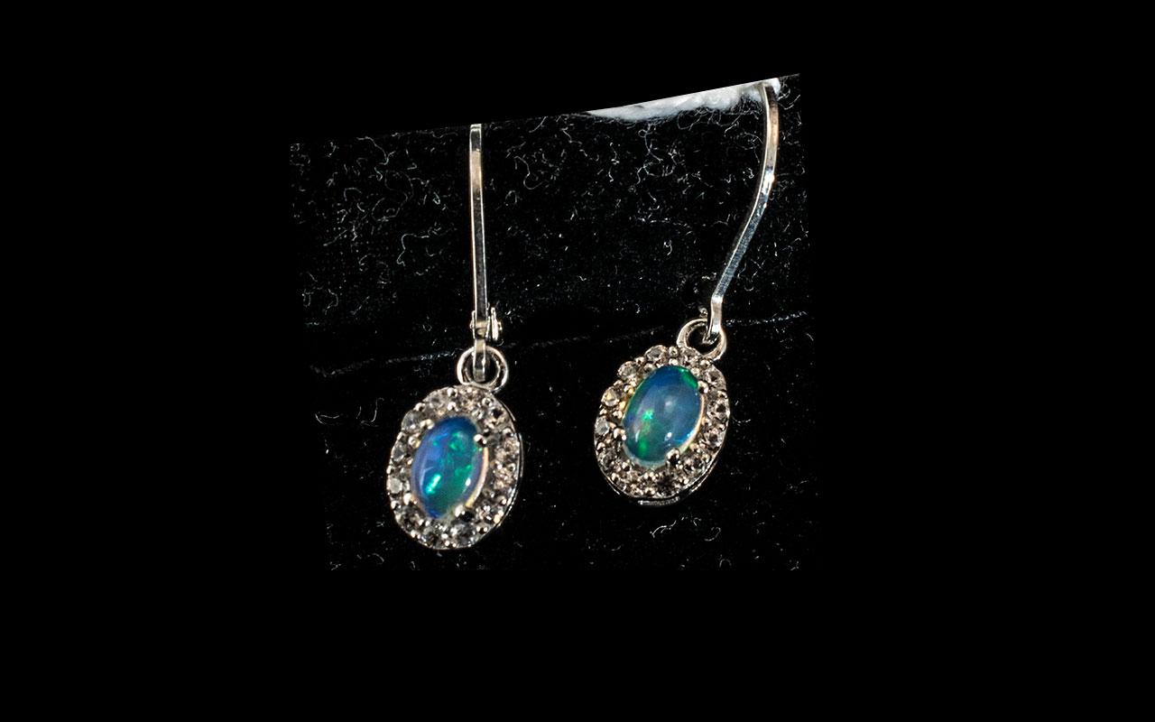 Opal Halo Set Drop Earrings, 1.5cts of oval cut opals, framed with halos of natural white zircons,