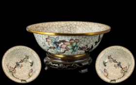 Japanese Cloisonne Bowl, decorated with floral and birds, raised on a wooden base. Diameter 7".