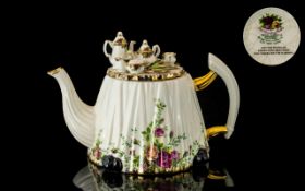 Large Royal Albert 'Old Country Roses' lid with setting of tea pots, cups and sandwiches on plates.