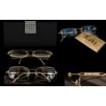 **WITHDRAWN**Three Pairs of Designer Spectacle Frames, including a pair of Tsuki 18ct gold frames,